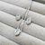 Conjunto de colar e brincos cravejados com zircônia central