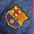 Image of Camisa Barcelona Treino 23/24 - Torcedor Nike Masculina - Grená com detalhes em dourado e preto