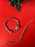 Pulsera tejida en plata rodinada con piedra cubic con cierre cabeza de puma y ojos en esmeraldinas