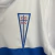 Kit Infantil Universidad Católica I Under Armour 23/24 - Branco com detalhes em azul e vermelho - loja online