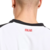 Camisa Reserva do Milan Puma 2025-2026 branca com detalhes vermelhos e pretos e o Diavoletto estilizado no escudo.