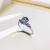 Solitário zircônia gota azul-turquesa e 2 zircônias rosa-pink