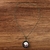 Colar charmoso com relicário em metal ouro velho com bordado arranjo circular flores rosa na internet