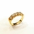 Meia Aliança de Zircones 18k