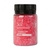 Frasco de sal espumante de banho cor rosa com rótulo indicando aroma de morango com champagne, 100g