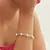 Pulseira de elos e perolas banhada a rodio na internet