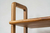 Biblioteca modular de madera con bordes curvos y detalles de calado para living de estilo mid-century modern