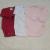 Kit com três bodies manga longa de bebê nas cores vermelho, branco e rosa claro.