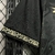 Detalhe da manga da camisa Botafogo II 24/25, na cor preta com acabamento em padrão claro.