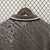 Camisa cinza do Real Madrid III 24/25, vista de trás, com detalhes do colarinho e logo RM.
