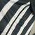 Camisa Atlético Mineiro Home 24/25 em preto e branco com listras largas.