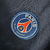 Logo do Paris Saint-Germain em uma camisa retrô azul