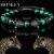 Pulsera cabezas de jaguar con zirconias y piedra ojo de tigre. (verde/humo)