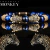 Pulsera cabezas de jaguar con zirconias y piedra ojo de tigre y baño de oro de 18k (azul/dorado)