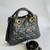 Bolsa de couro preta com detalhes em ouro, estilo elegante e sofisticado.