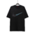 T-shirt Nike Butterfly em branco e preto, com estampa de borboletas na logo.