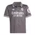 Camisa infantil do Real Madrid I Adidas 23/24 na cor cinza com detalhes em branco e preto.