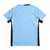 Camisa masculina da Seleção do Uruguai, na cor azul com detalhes em branco e preto, vista pela parte de trás.