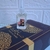 Frasco de perfume Decant Sabah Al Ward Al Wataniah de 10ml sobre uma embalagem decorada.