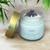 Vela perfumada Conexão Interior d'alma, com tampa dourada, contendo cera de coco 160g e pedras de ametista.