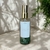 Frasco do aromatizador de ambiente Leveza do Ser, energizado com cristais de quartzo verde e aroma fresco de alecrim.