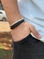 PULSEIRA DE COURO PRETO NÃO AJUSTÁVEL 1 TIRA LISA 2 TRANÇADOS