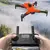 Dron Alpha Explorer Prime X8 em voo com controle remoto em uma paisagem neblinada.