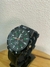 Reloj Grand Touring con numeros en verde en internet