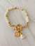 Pulsera con San Benito pompon
