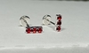 Abridores. Diseño lineas de 3 mini circonias rojas.