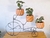 Base para macetas con forma de bicicleta.