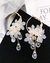 Aretes con flores y gotas de lluvia en internet
