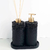 Essenza Volcano Lavatory Kit featuring two black holders with a pump and reed diffuser atop a circular base.