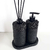 Essenza Volcano Lavatory Kit featuring a black soap dispenser and a diffuser with black reeds, set on a matching base.