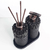 Essenza Volcano Lavatory Kit featuring two black stone-like containers with wooden sticks and a pump dispenser, set on a matching tray.
