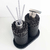 Essenza Volcano Lavatory Kit featuring two black textured containers, one with a pump dispenser and the other with reed sticks, on a matching tray.