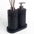 Essenza Volcano Lavatory Kit featuring two black stone-like dispensers with decorative tops and a matching base.