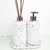 Kit Lavabo Milão com dispenser e difusor em material branco com partículas escuras.
