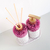 Kit Lavabo Malaya com frascos decorativos de cristal rosa e detalhes em dourado.