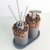 Kit de aseo Pekín con dispensador y dos frascos decorativos de piedras, ideal para el lavabo.
