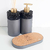 Kit lavabo Tóquio em estilo moderno, com dispensador e frascos decorativos em cinza e detalhes em preto e dourado.