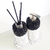Kit Lavabo Paris com frascos decorativos em preto e branco, contendo um dispenser e varetas aromáticas.