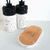 Kit Lavabo Paris com dois frascos decorativos de pedra, um suporte de cortiça e design moderno.