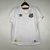 Camisa branca do Santos FC, modelo 23/24, da marca Umbro, com detalhes em preto e amarelo.