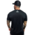 Camiseta Tradicional Alltime em cor preta, modelo masculino, com logo frontal em branco.