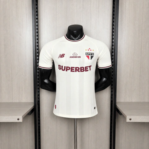 Camisa Comemorativa / Terceira (III) do São Paulo FC 2026/2027 da New Balance, em tom off-white com detalhes em bordô inspirados na alfaiataria clássica