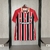camisa modelo torcedor são paulo ii temporada 25/26 nas cores vermelho com faixas preta e branca e detalhes dourado na gola e nas mangas