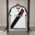 Camisa masculina do Vasco da Gama II 24/24, versão torcedor, em branco com detalhes em preto e vermelho, pendurada em um cabide.