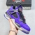Tênis Nike Air Jordan 4 Retro na cor roxa, com detalhes em preto e vermelho, segurado na mão.