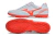 White and orange soccer cleats with a sleek design and textured soles.
